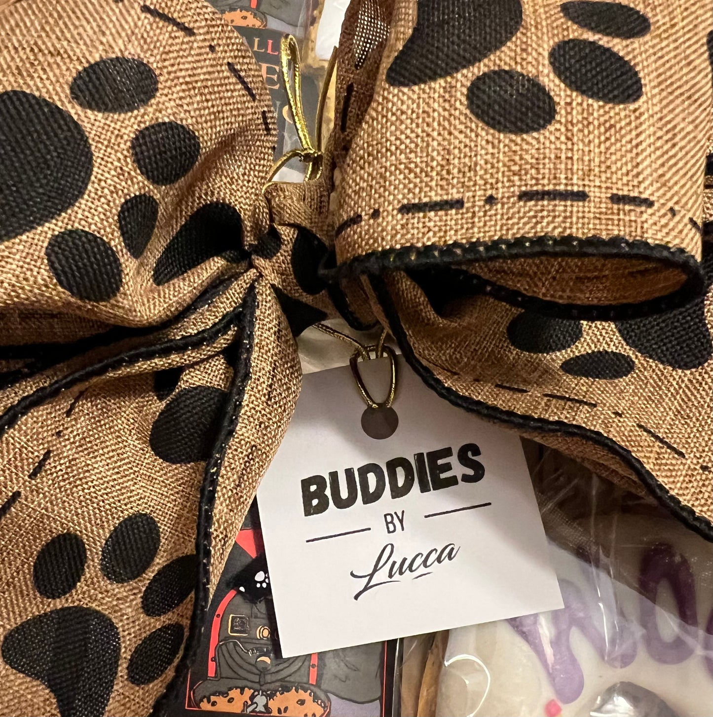 close up image of buddies by lucca hangtag on gift